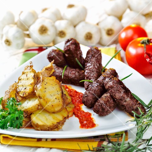 Cevapcici with grilled potato slices