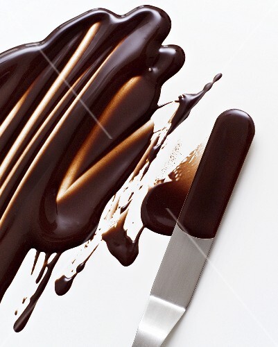 Melted chocolate icing on a palette knife