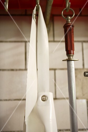 Butcher's apron and sharpening steel on hooks