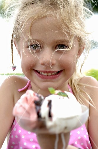 Blond girl with a mixed ice cream sundae