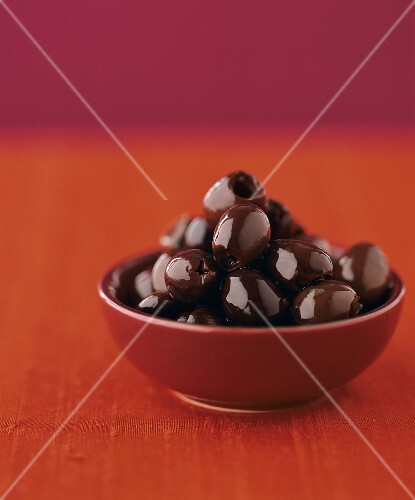 Black olives in oil in a small bowl