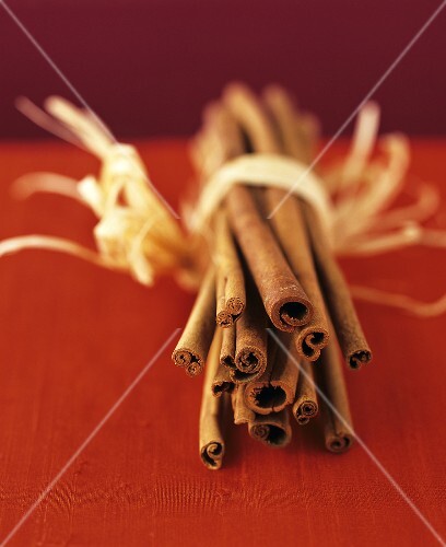Several cinnamon sticks tied together with raffia
