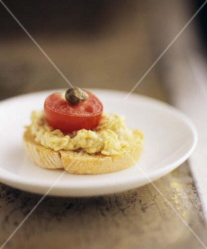 Leek and cheese spread, tomato and caper on crostino
