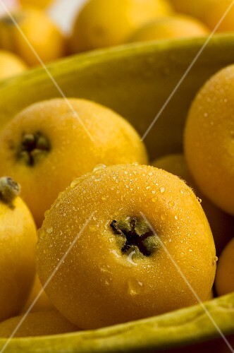 Several medlars in and beside a bowl