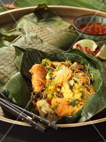 Salmon with turmeric & glass noodles in banana leaf, fish sauce