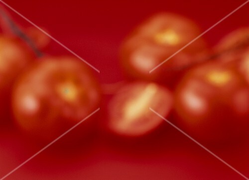 Tomatoes on red (artistic shot)