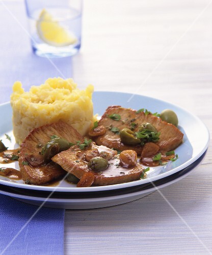 Pork with garlic and olive sauce and mashed potato