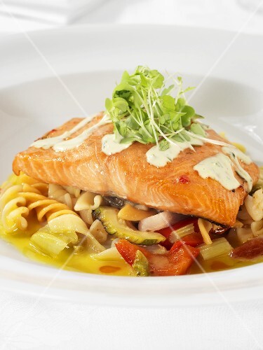 Salmon fillet on pasta & vegetables, garnished with cress