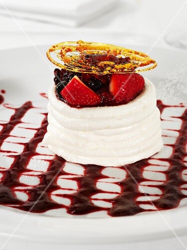 Meringue basket filled with berries, with caramel lattice