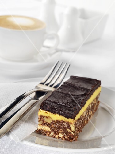 Chocolate nut slice with cup of cappuccino