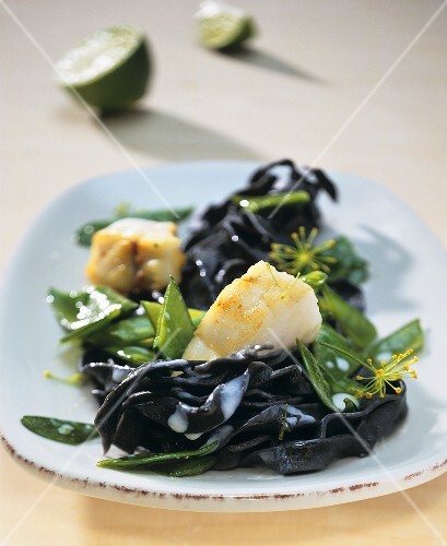 Squid ink pappardelle with fried zander and mangetout