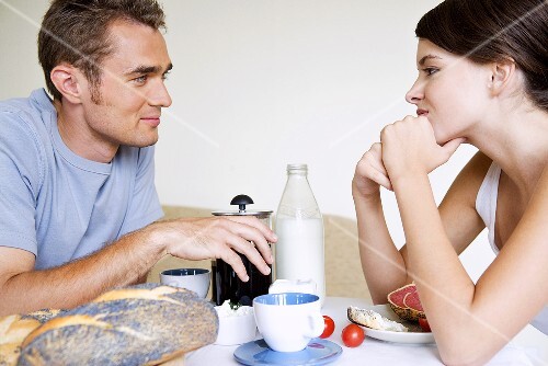Young couple sitting at breakfast table