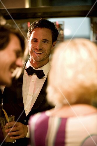 Bartender and guests in bar