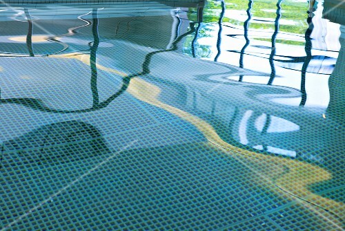 Reflective water surface in indoor swimming pool