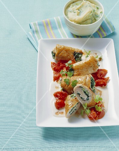 Veal rolls with spinach stuffing and tomatoes