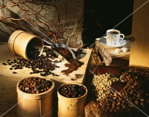 Coffee beans, ground coffee and a cup of coffee