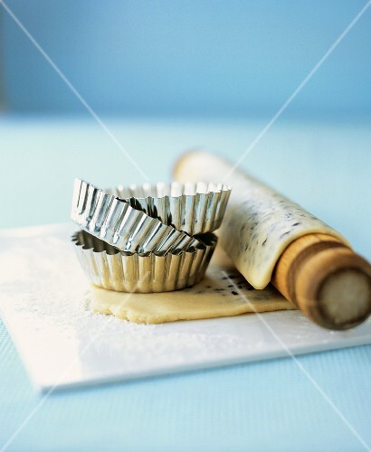 Tartlet tins and rolling pin with savoury shortcrust pastry