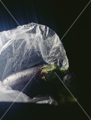 Aubergine with drops of water in a plastic bag