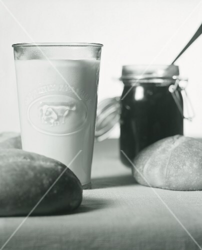 Still life with milk, jam and bread rolls (b-w shot)