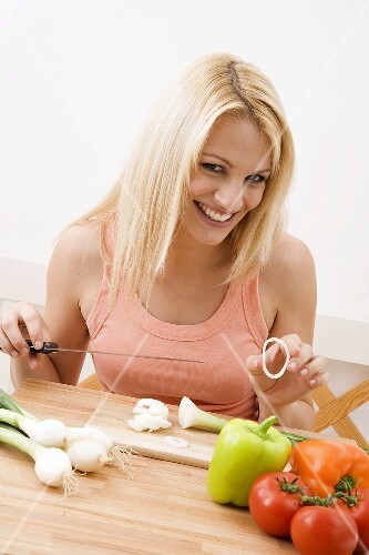 Young woman slicing vegetables