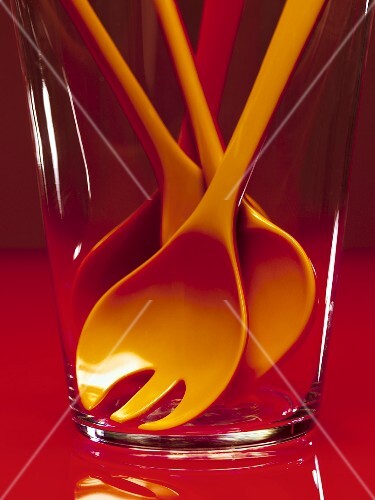 Cooking spoons (red and orange) in a glass