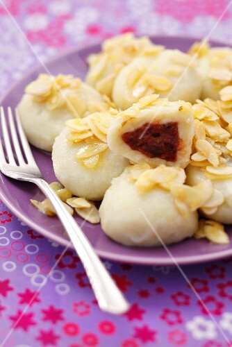 Potato dumplings with plum filling and buttered almonds