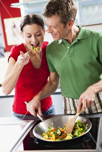 Woman tasting fried vegetables
