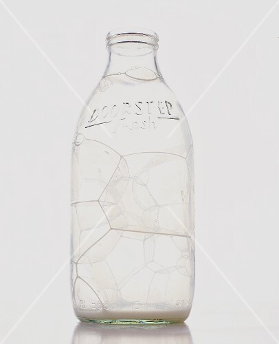 An empty milk bottle with bubbles