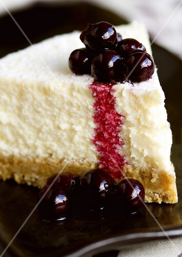 A piece of cheesecake with blackcurrants