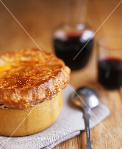 Steak and ale pie, red wine in background