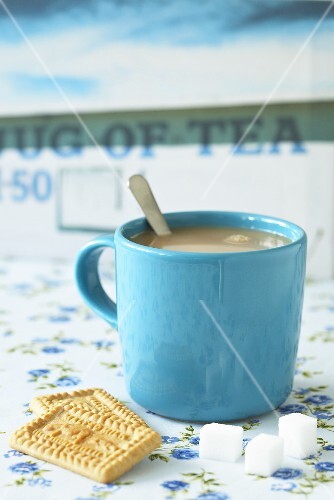 Mug of tea, malted milk biscuits and sugar cubes (UK)
