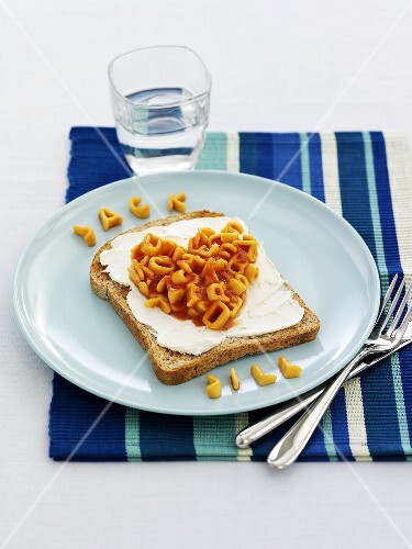 Bread with cream cheese and alphabet pasta for children