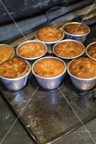Several sponge puddings in pudding basins