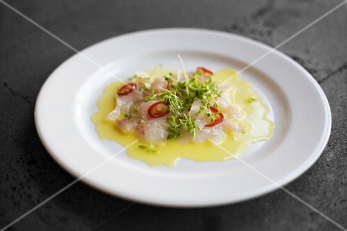 Fish carpaccio with chilli rings and cress