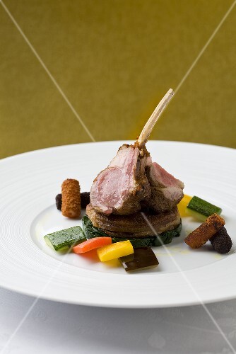 Lamb chops on baby spinach and vegetables