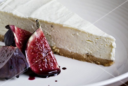 A piece of vanilla cheesecake with figs