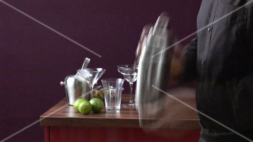 Shaking a cocktail vigorously in a shaker