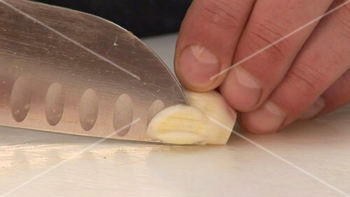 Chopping a clove of garlic