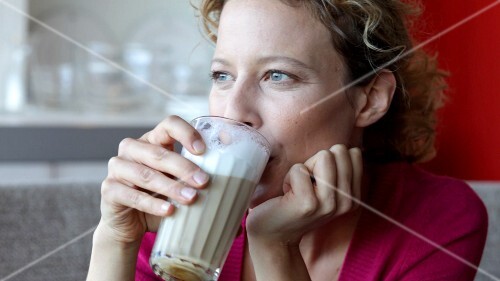 Woman drinking latte macchiato