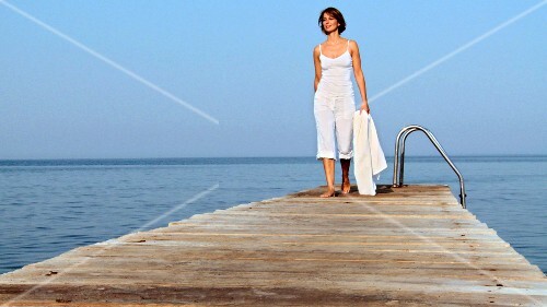 Young woman walking along a landing stage