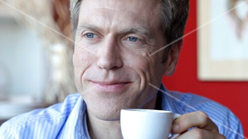 Man drinking a cup of espresso