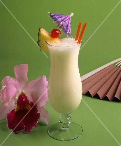 A Glass of Pina Colada with Fruit and a Cocktail Umbrella
