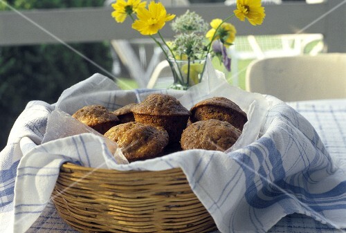 Bran Muffins in a Basket on an Outdoor Table