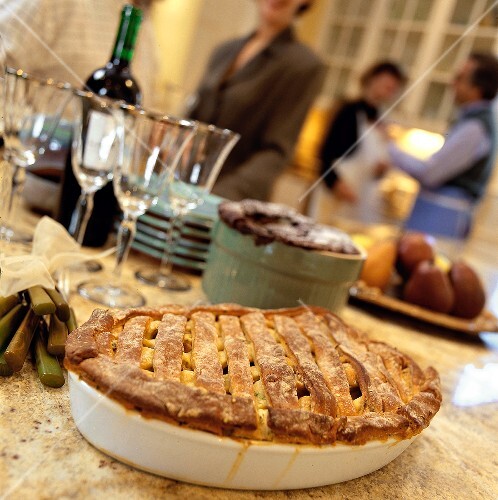 Party buffet with pie in foreground and people