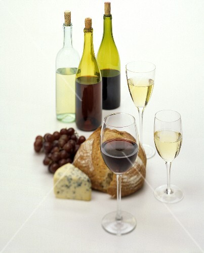 Still life with wine, bread, cheese and grapes