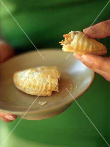 Hands Holding a Chicken Empanada