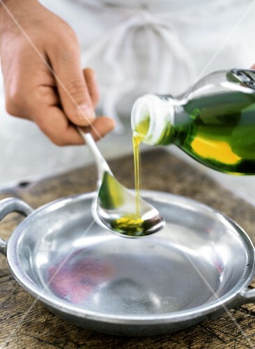 Pouring olive oil into spoon