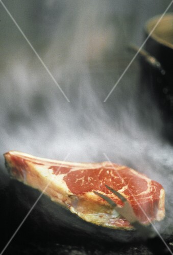 A Rib Steak Being Grilled