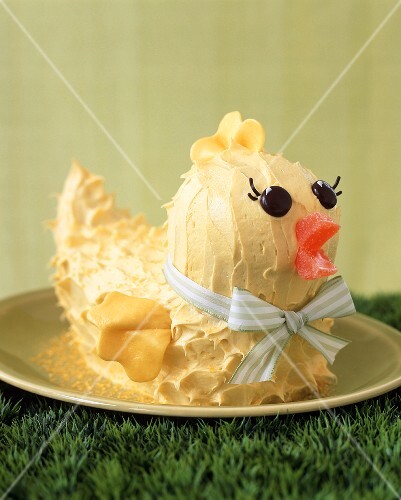 Yellow Chick Cake on a Plate on Grass for Easter