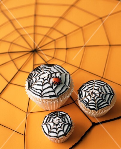 Three Spider Web Cupcakes on Spiderweb Table Top for Halloween